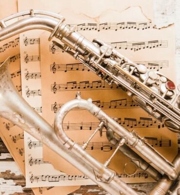 Primer plano de saxofón y trompeta en partituras